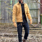 Front view of custom-made sand canvas chore jacket with metal buttons.