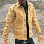 Close up view side of custom-made sand canvas chore jacket with metal buttons.